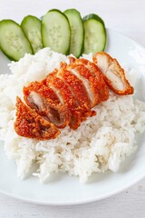 Fried Chicken Rice And cucumber on a white plate isolated on a white background