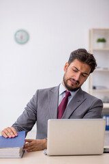 Young male employee working in the office