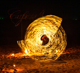 Fire show on the beach at night in Phuket, Thailand