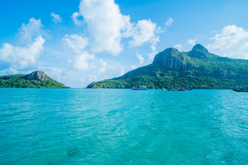 Panoramic coastal Con Dao view from above, with waves, coastline ,clear sky and road, blue sea and mountain.