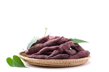 Organic purple sweet potatoes in basket on white background