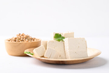 Organic tofu on natural plate with white background, Vegan food ingredients in Asian cuisine, plant based