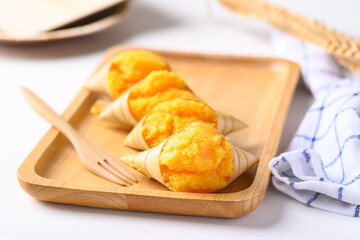 Homemade Toddy palm cake on wooden plate with white background, Thai traditional dessert