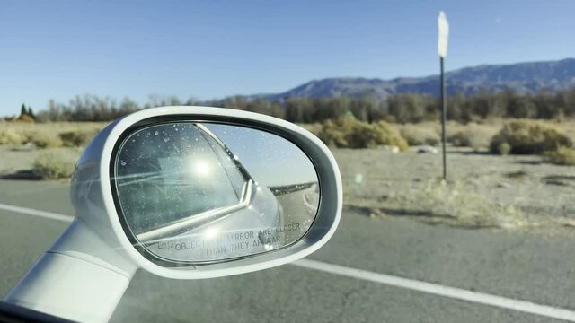 Mirror of a car driving thru the California desert