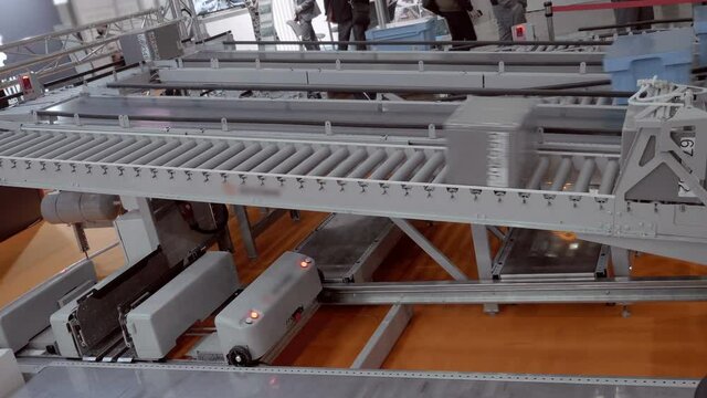 Belt conveyor and gravity roller conveyor is a transport line for moving various types of goods: plastic containers in the warehouse and in production, cardboard boxes in the post office and customs 