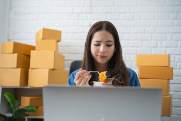 Asian business woman eating noodle at work for lunch time with unhappy face