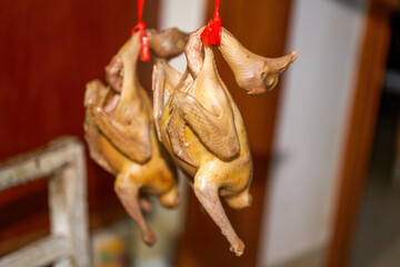 Fototapeta premium Two braised pigeons being air-dried, semi-finished Cantonese roast meat