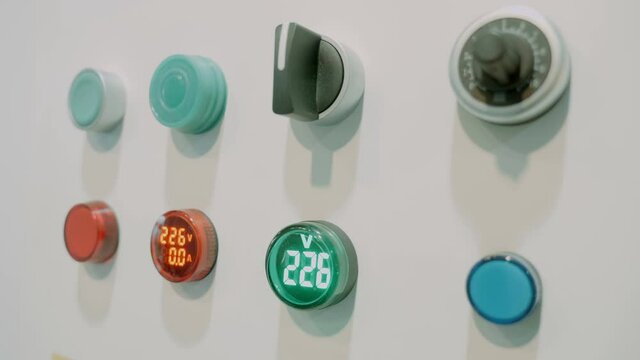 Rows of new light bulbs, switches, regulators and digital voltage indicators for industrial equipment. Shot in motion. Closeup