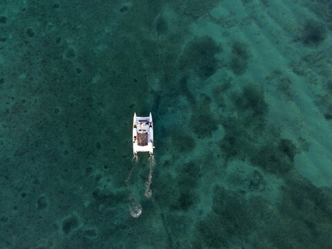 Aerial photo of a boat on the beach of Cozumel in Mexico
