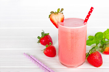 Strawberry yogurt fruit juice smoothie pink colorful fruit juice milkshake blend beverage healthy high protein the taste yummy In glass drink episode morning on white wood background.