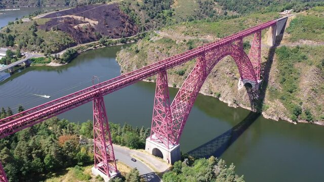 Picturesque summer landscape of Truyere river with Garabit Viaduct, French railway arched viaduct in Cantal department