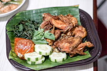 Fried chicken on a plate with chili sauce