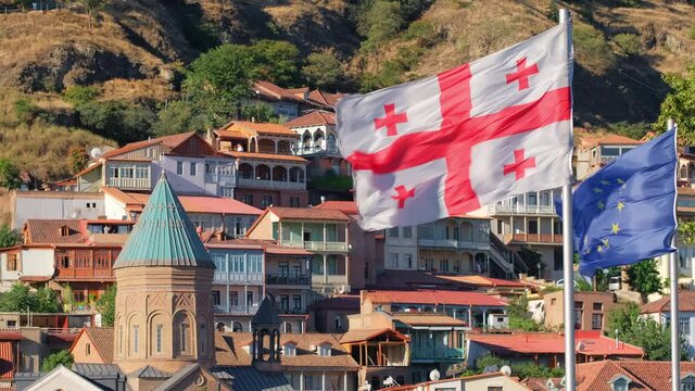 Georgian and European Union waving flags in Tbilisi old town, Georgiac