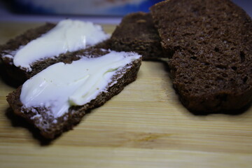 Sandwich with butter. Bread buttered on a kitchen board