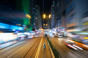 Fototapeta na wymiar Night scenery of abstract traffic background viewed from speed motion train through downtown district of Hong Kong city