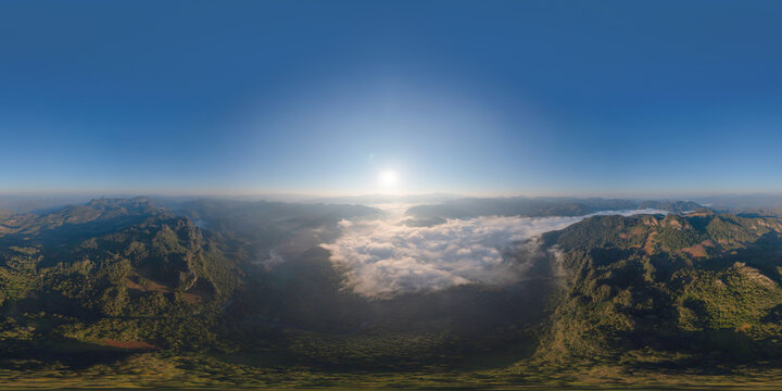 360 panorama by 180 degrees angle seamless panorama of aerial top view of forest trees and green mountain hills with sea fog, mist and clouds. Nature landscape background, Thailand.