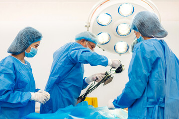 Professional anesthesiologist doctor medical team and assistant preparing patient to gynecological surgery performing operating with surgery equipment in modern hospital operation emergency room