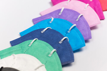 close up to face masks on bright desk. Protection against coronavirus, flu and other airborne...