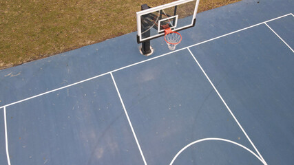 A colorful blue basketball court at a local park