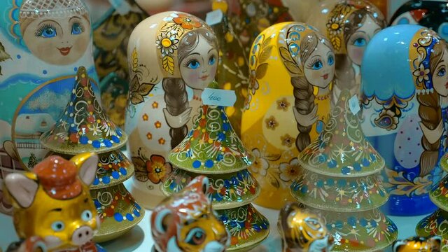 Created of wood and richly painted Russian folk souvenirs - a row of matrioshka (nesting dolls), Christmas trees, animals symbols of the year ​- are very beautiful and shine with brightly lacquered su