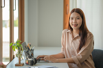 Young female photographer working in her home office studio