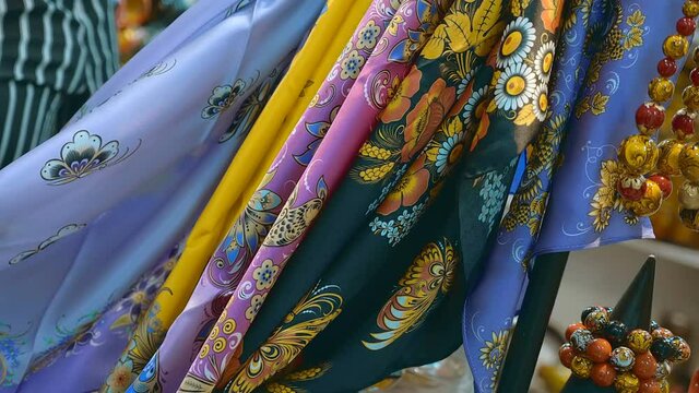 Women's head scarves are made of beautiful colorful fabric in Russian folk style. Closeup