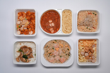 Top view of various frozen meal on white background.