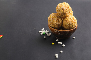 Indian sweet for traditional festival makar sankranti :Rajgira laddu made from Amaranth seed in Bowl on white background.