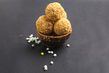 Indian sweet for traditional festival makar sankranti :Rajgira laddu made from Amaranth seed in Bowl on white background.