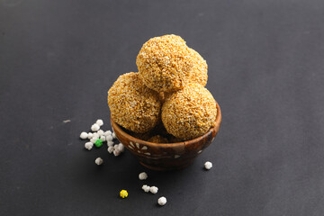 Indian sweet for traditional festival makar sankranti :Rajgira laddu made from Amaranth seed in Bowl on white background.