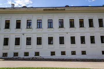 the wall of a stone three-storey building