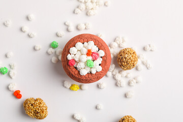 Indian festival makar sankranti concept : Tilgul in small bowl. Tilgul is a colourful sesame candy...