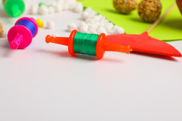 Spool with colourful thread or manjha or dark background. Indian festival makar sankranti concept