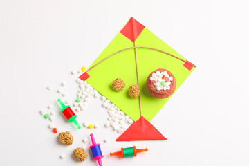 Indian festival makar sankranti concept, Colorful kite ,string and sweet sesame seed ball.