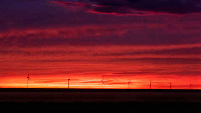 Taken in the Texas panhandle at sunrise.  Windmill electric farm in the distance.