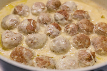 Swedish meatballs in a creamy white sauce step by step recipe. Meatballs close up on frying pan