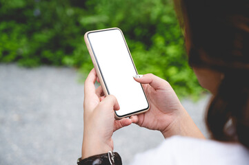 Close up women using a smartphone with empty white screen at the outdoor.