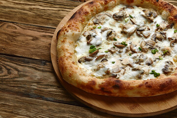 Delicious homemade pizza with mozzarella, mushrooms, beef and chicken. Wooden background, selective focus.