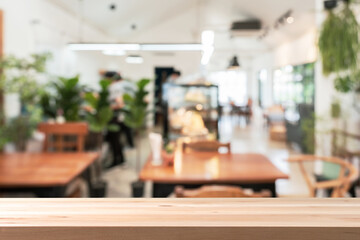 Empty wooden table space platform and blurry defocused restaurant interior and coffee shop