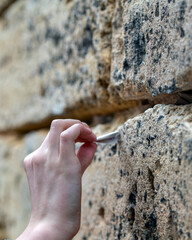 Hand with a note, Jewish tourist at the Wailing Wall in Jerusalem, Israel