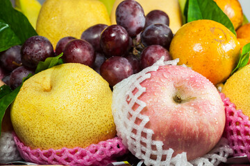 Naklejka na ściany i meble Fresh fruit in the basket on a white background.