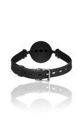 Detailed shot of a mouth gag made as a black silicone ball with breathing holes on a black leather belt. The accessory for erotic games is located on the white backdrop. Back view.