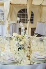 Luxurious restaurant. Luxurious interior, white tables, serving dishes and glasses for guests
