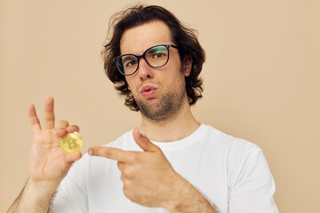 Attractive man with glasses gold bitcoin in hands Lifestyle unaltered