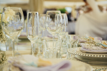 Luxurious restaurant. Luxurious interior, white tables, serving dishes and glasses for guests