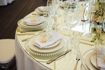Luxurious restaurant. Luxurious interior, white tables, serving dishes and glasses for guests