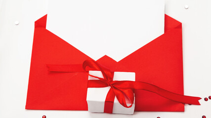 Valentines day greeting card mockup, red envelope and gift box on white background