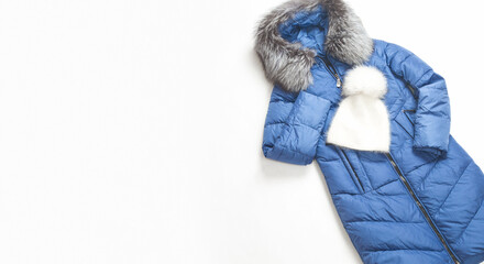 Warm jacket on a white background. Women's stylish autumn or winter clothes. Cozy winter look. Flat lay, top view.