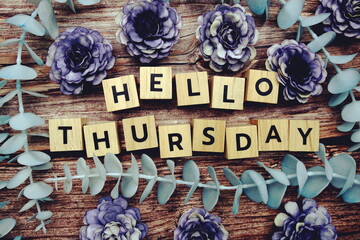 Hello Thursday alphabet letter and flower decorate on wooden background