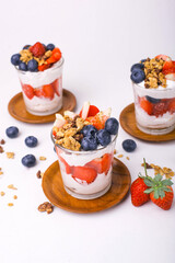 Japanese popular dessert parfait made with fresh fruit, yogurt and granola isolated on white background